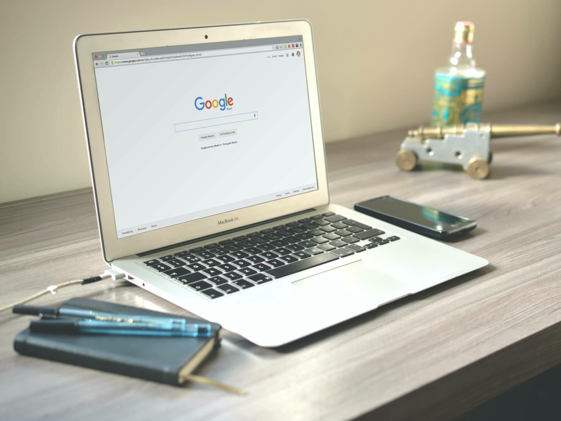 A laptop on a desk with Google open on the screen.