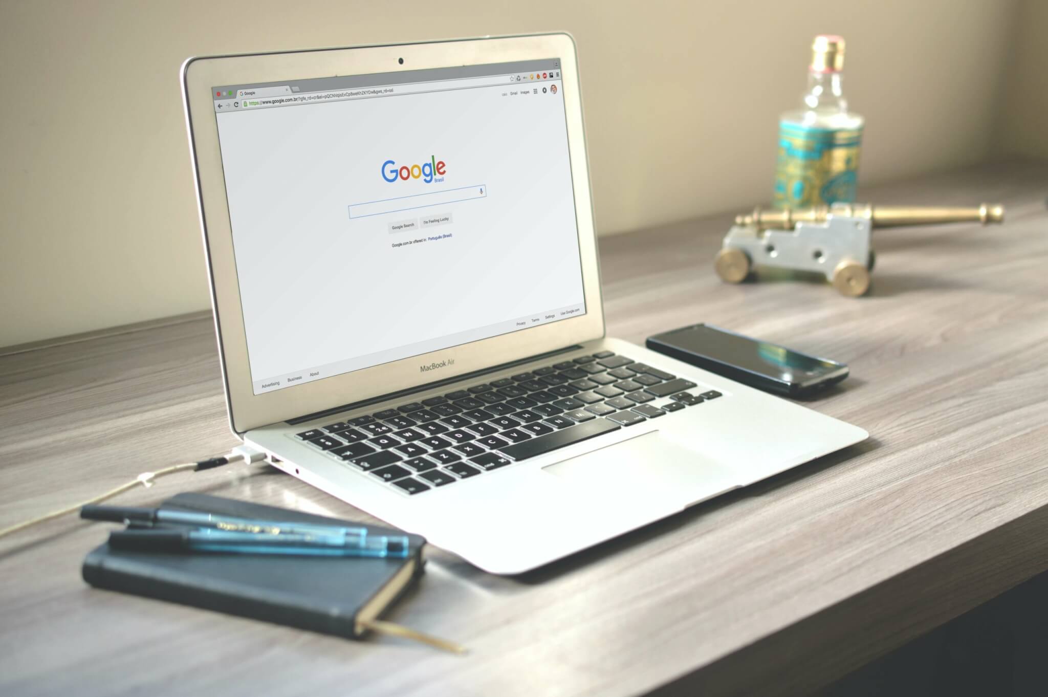 A laptop on a desk with Google open on the screen.