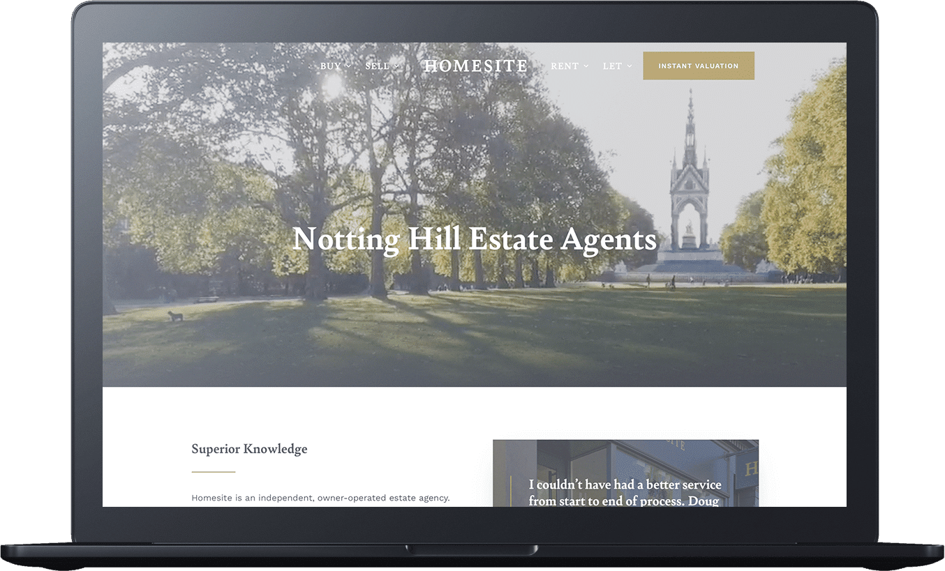 Laptop screen displaying a real estate website with an image of a park and church in the background, showing