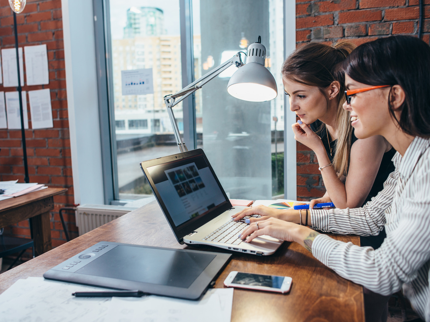 Two female website designers, designing a website