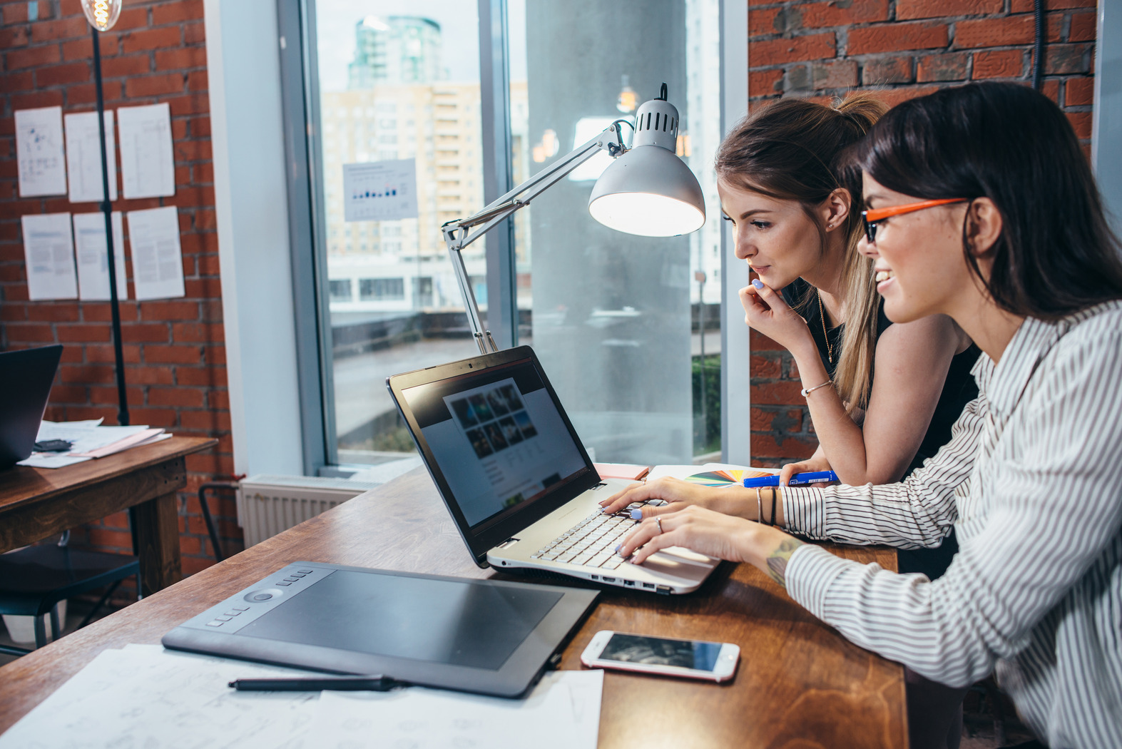 Two female website designers, designing a website