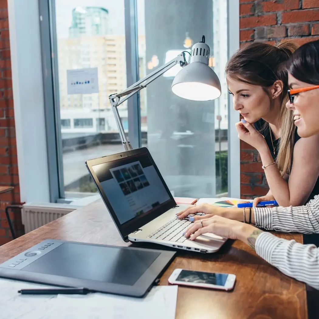 Two female web designers, designing a website