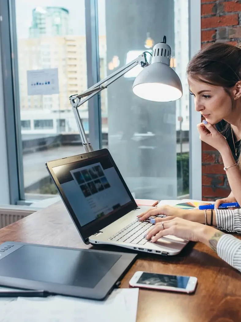 Two female web designers, designing a website