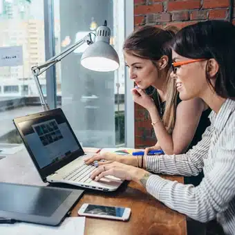 Two female web designers, designing a website