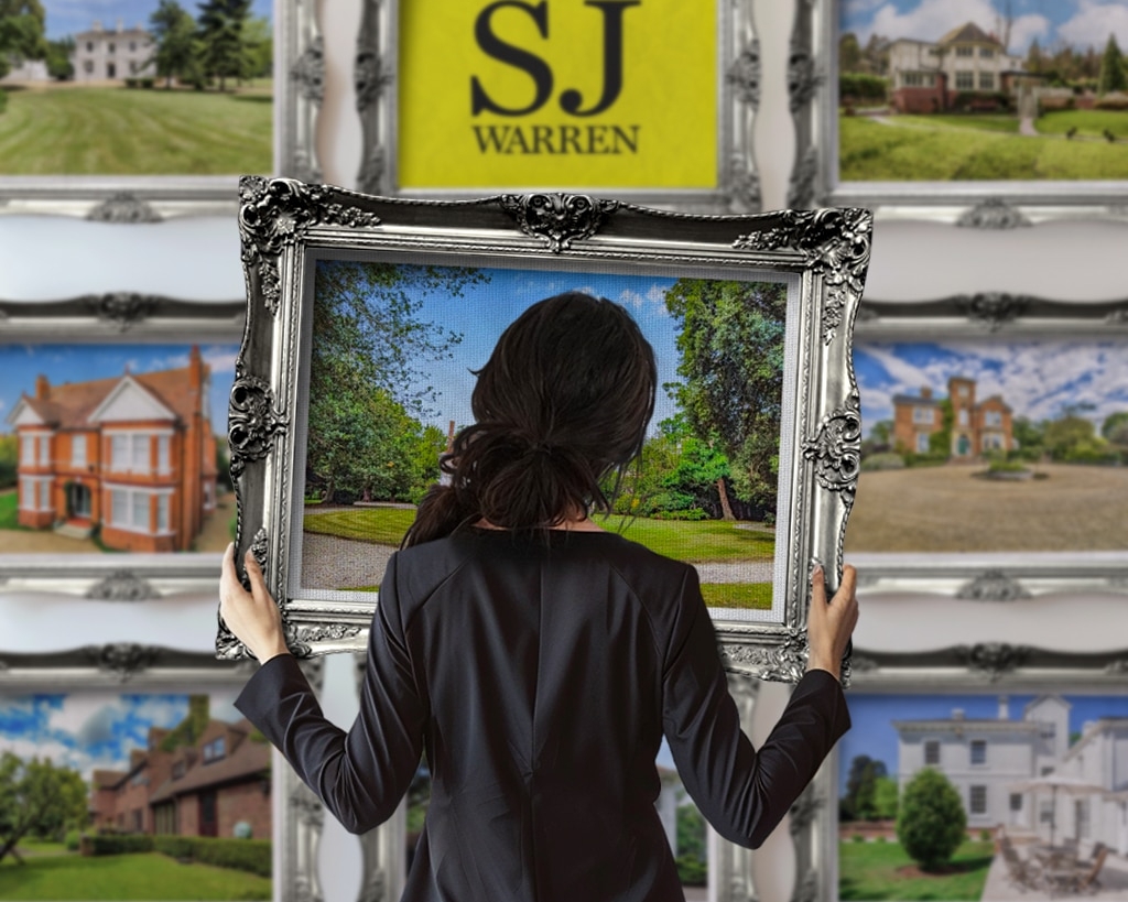 A woman holding a picture frame, ready to make new memories—brought to you by SJ Warren Estate Agents.